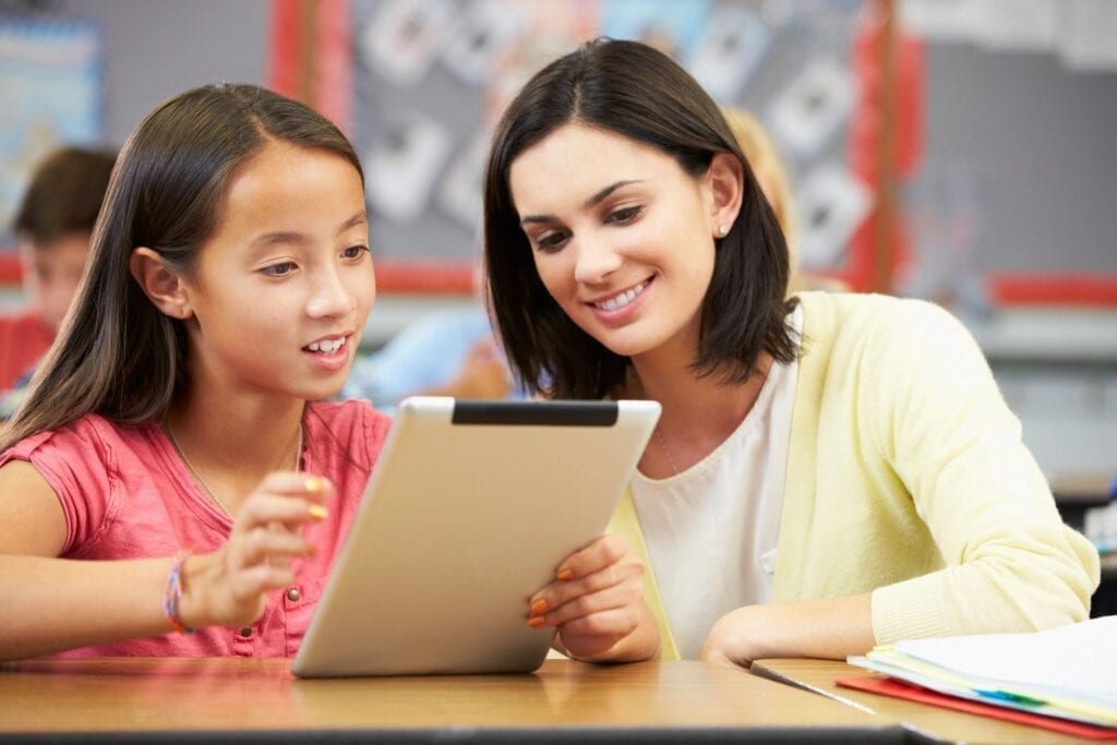 A Student Showing Her Work in a Tablet Computer to Her Teacher